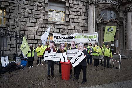 Aktivisten mit Masken von Wirtschaftsminister Habeck (l-r), Bauministerin Geywitz, Bundeskanzler Scholz und Verkehrsminister Wissing protestierten  vor dem Oberverwaltungsgericht Berlin.